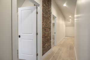 Hallway featuring recessed lighting, lofted ceiling, and light wood finished floors