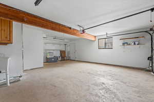 Garage featuring a sink and a garage door opener