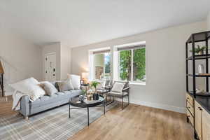 Living room with light wood-style flooring and baseboards