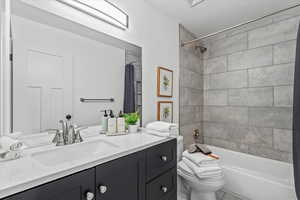 Full bathroom featuring shower / bath combo and vanity