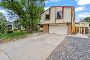 View of front facade featuring concrete driveway, a garage, and brick siding