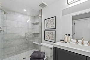 Bathroom featuring vanity, a shower stall, and recessed lighting