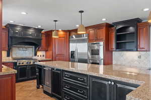 Kitchen with tasteful backsplash, recessed lighting, appliances with stainless steel finishes, dark cabinetry, and light tile patterned floors