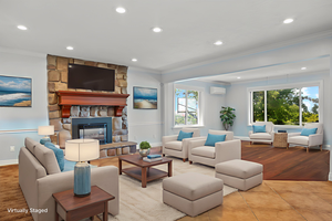 Living room featuring ornamental molding, recessed lighting, a fireplace, a wall mounted air conditioner, and wood finished floors