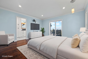 Bedroom with crown molding, wood finished floors, access to outside, recessed lighting, and ensuite bath