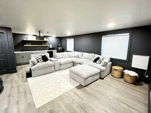 Living room with light wood-style flooring and bar area