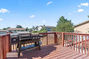 Wooden terrace featuring a residential view
