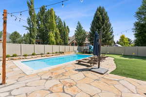 View of pool with a patio and a fenced backyard