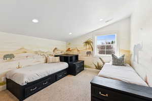 Bedroom with lofted ceiling, recessed lighting, and light carpet
