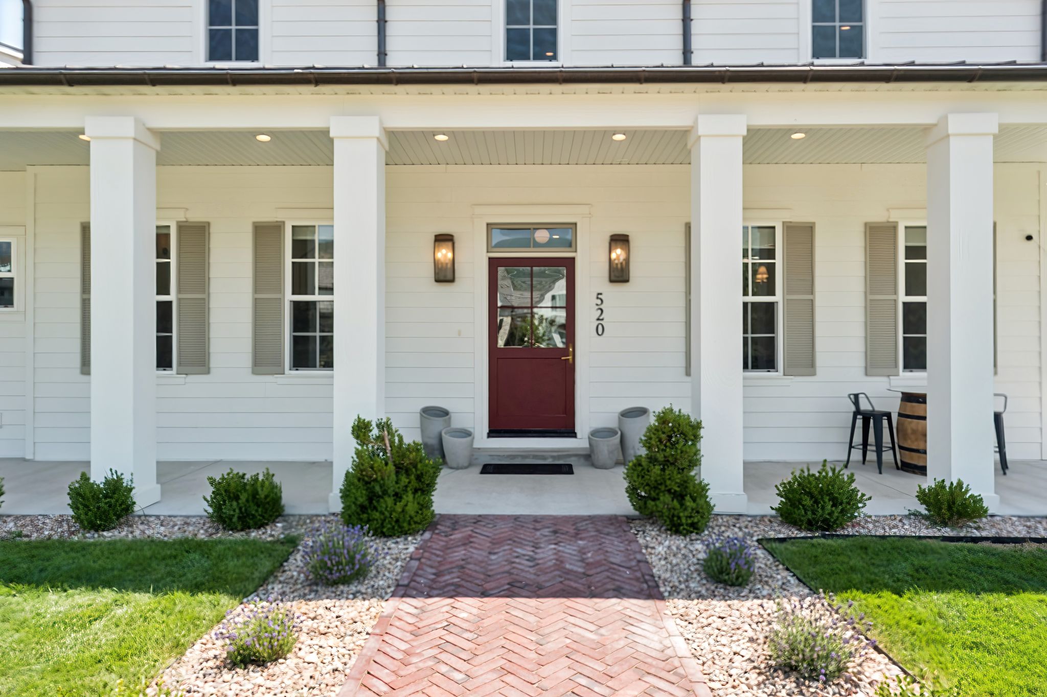 Property entrance with covered porch and a yard