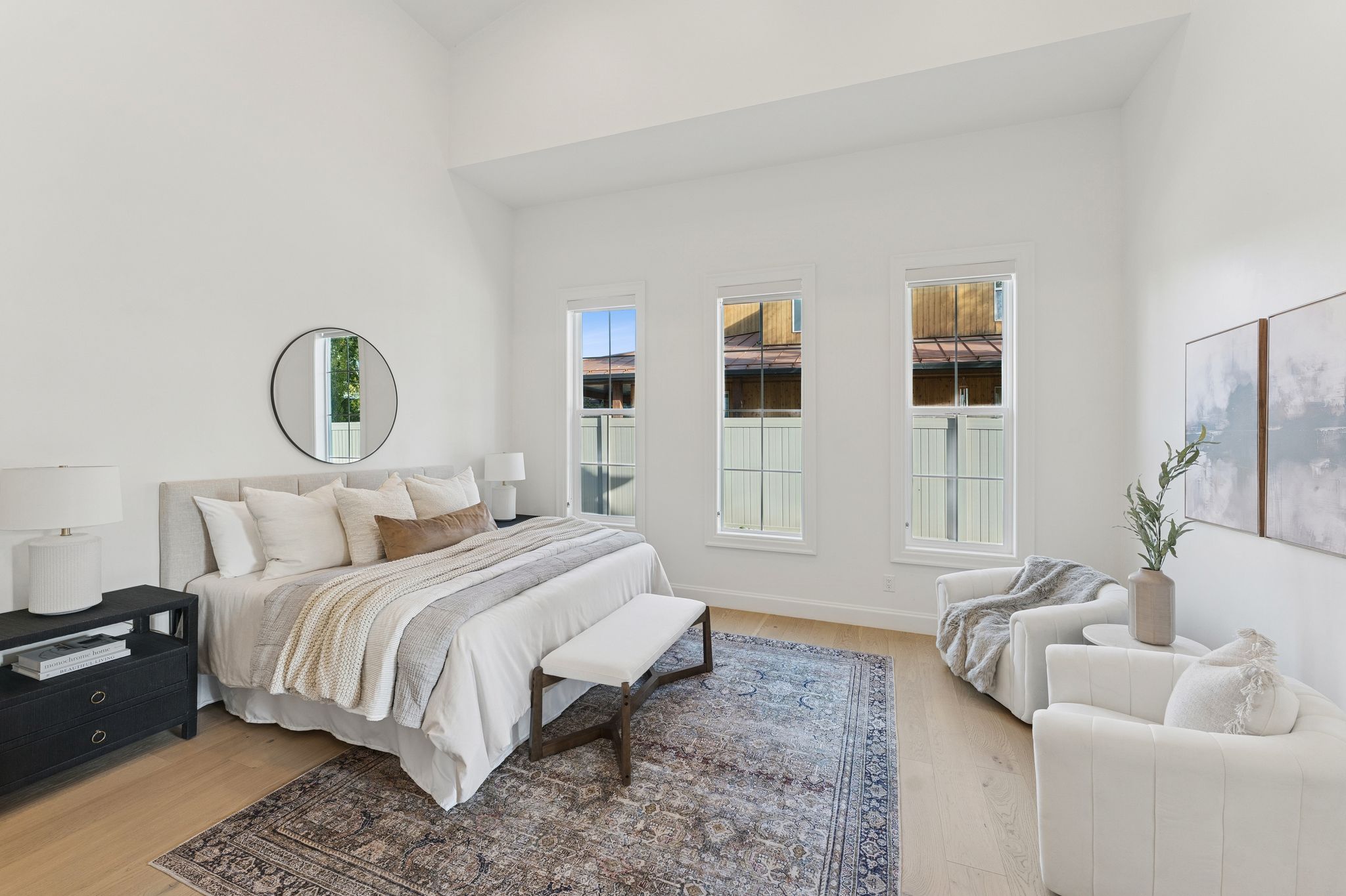 Bedroom with light wood finished floors and a towering ceiling