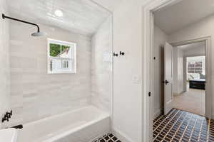 Full bath featuring shower / bathtub combination and tile patterned floors