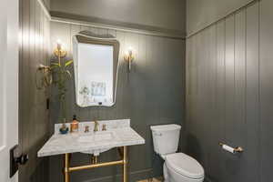 Half bath with a sink and toilet