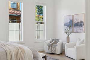 Bedroom with wood finished floors and baseboards