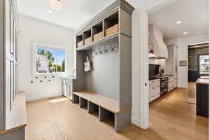 Mudroom featuring light wood-style flooring and recessed lighting