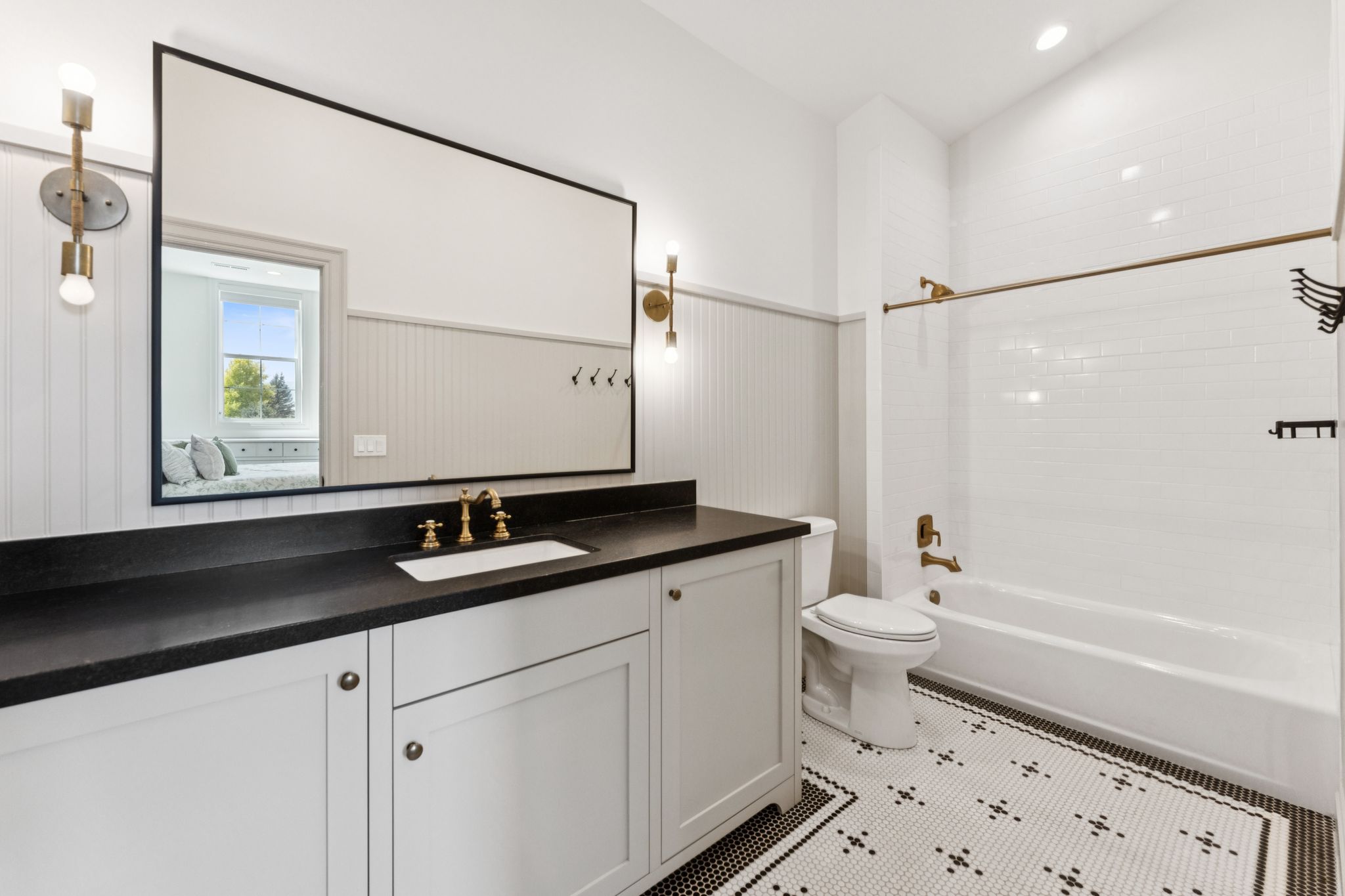Ensuite bathroom featuring shower / washtub combination, vanity, and light tile patterned floors