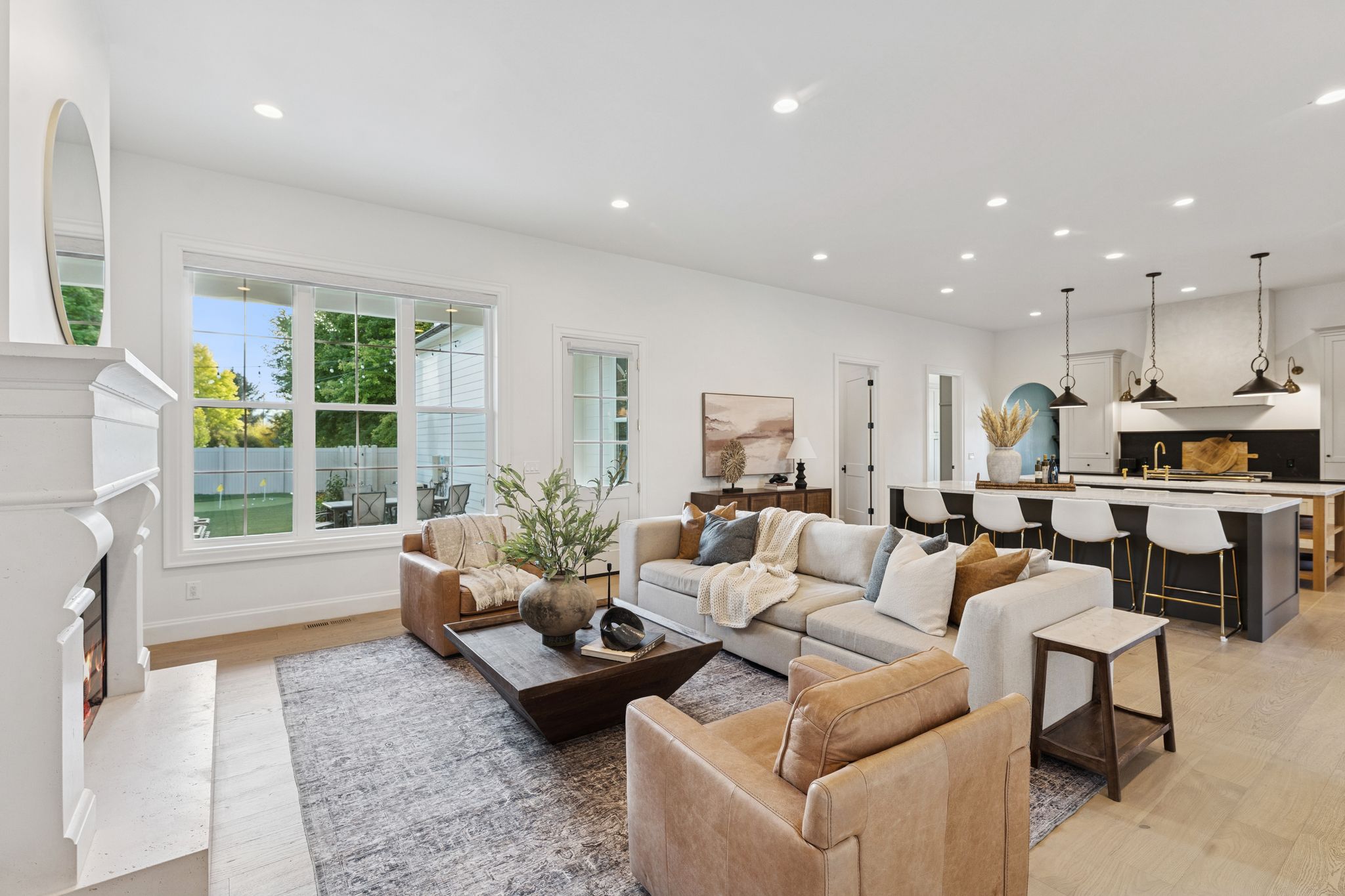 Living area featuring recessed lighting, light wood-style floors, and a premium fireplace