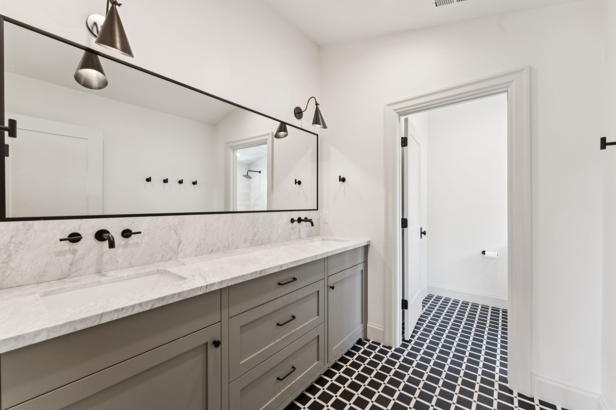 Bathroom featuring double vanity and a shower