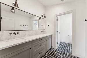 Bathroom featuring double vanity and a shower