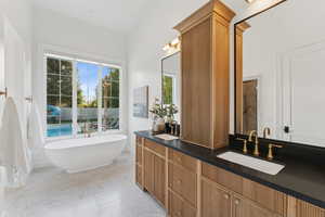 Bathroom featuring double vanity and a freestanding bath