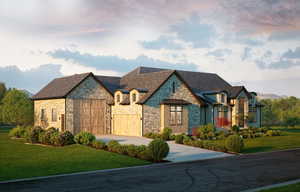 French country style house featuring a front yard, concrete driveway, an attached garage, and stone siding