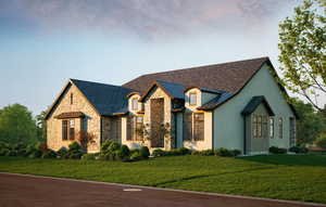 French country inspired facade with a standing seam roof, a metal roof, and a front yard