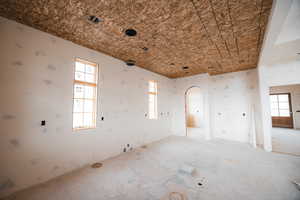 Spare room featuring arched walkways