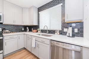 Modern backsplash, quartz countertops, large single basin stainless steel sink