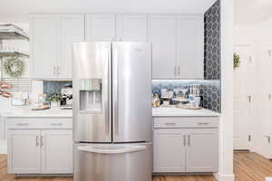 Designated fridge nook with surrounding counterspace.