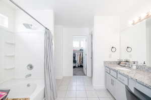 Primary bathroom with separate toilet room and large walk in closet with natural lighting