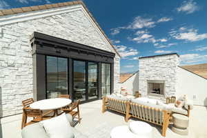 View of patio featuring an outdoor living space with a fireplace and outdoor dining space