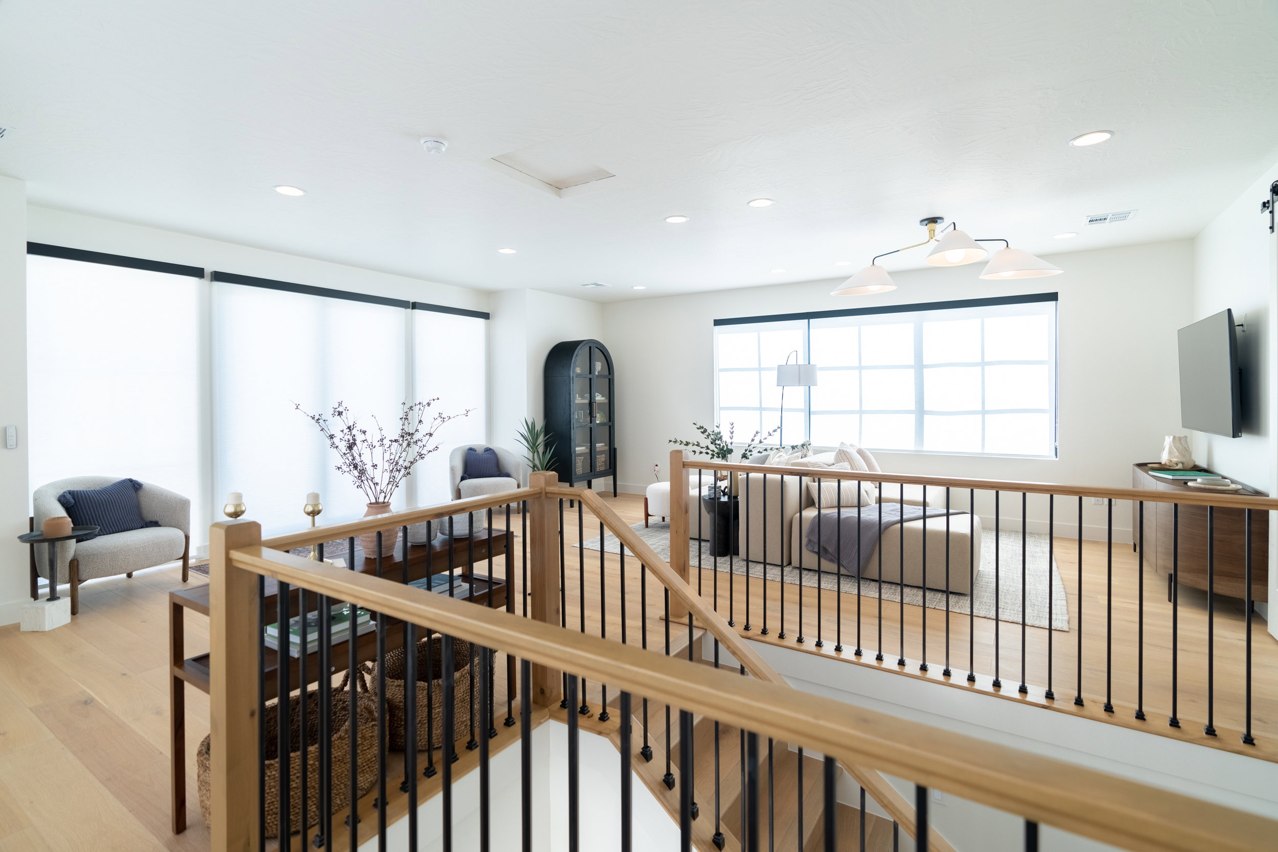 Stairs featuring wood finished floors and recessed lighting