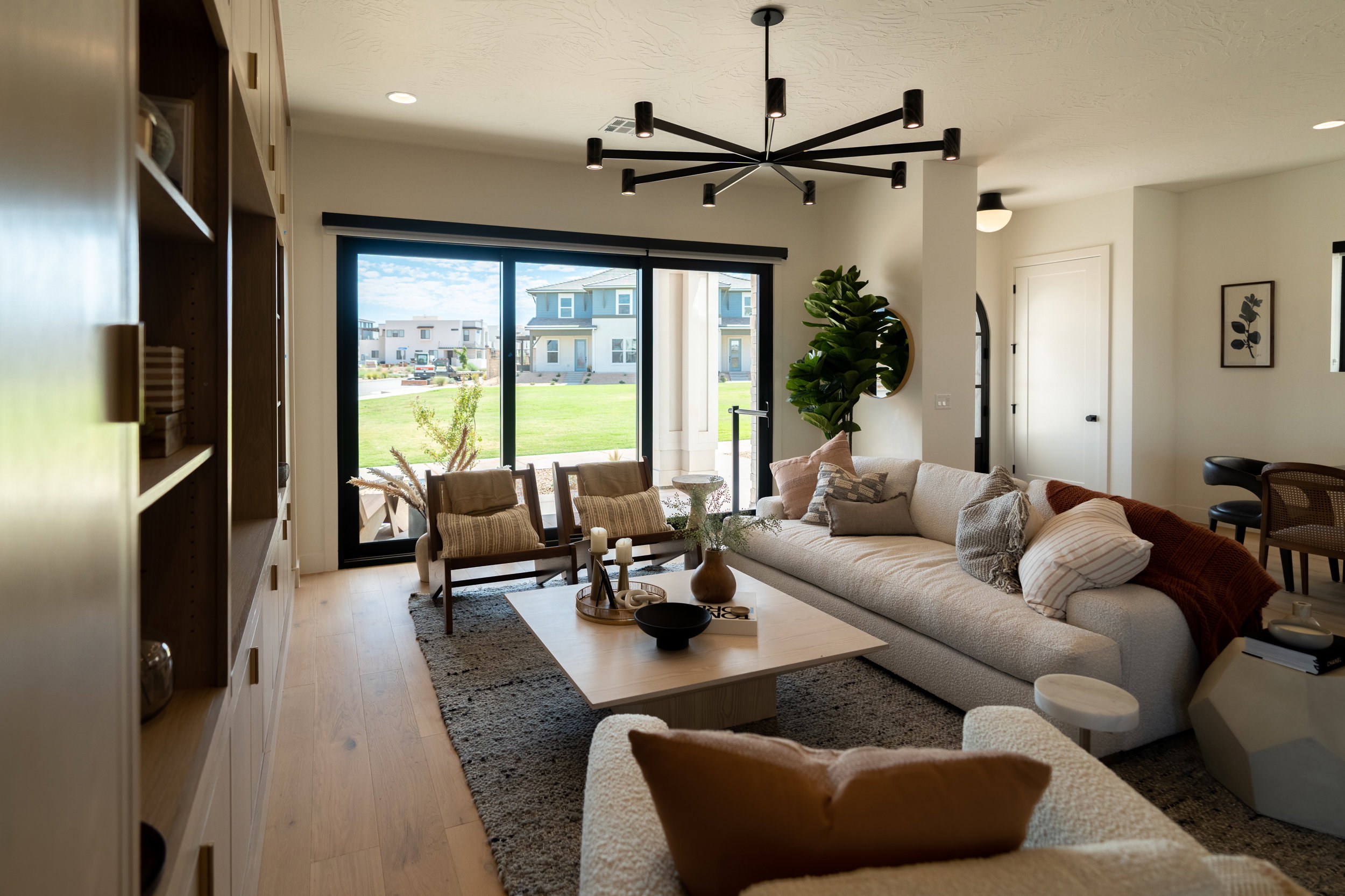 Living room with light wood-style floors, recessed lighting, a chandelier, and a textured ceiling