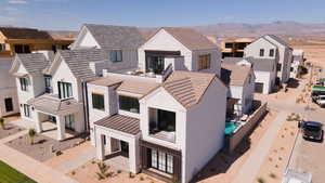 View of front of home featuring a residential view, a mountain view, a standing seam roof, and a metal roof