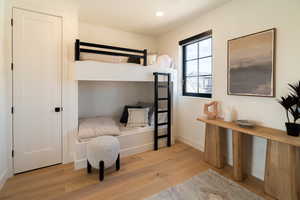 Bedroom with light wood finished floors and recessed lighting