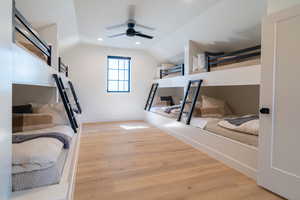 Bedroom with light wood-style floors, vaulted ceiling, ceiling fan, and recessed lighting