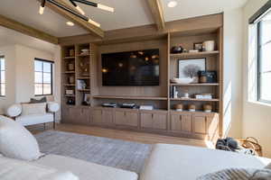 Living area featuring beam ceiling, built in shelves, light wood-type flooring, and recessed lighting
