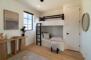 Bedroom featuring light wood finished floors, a ceiling fan, and recessed lighting