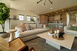 Living area featuring stairs, recessed lighting, and a wood ceiling with exposed beams