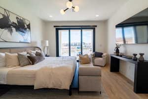 Bedroom with light wood-type flooring, access to exterior, and recessed lighting