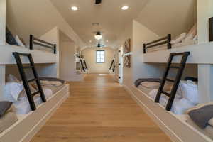 Hallway featuring light wood-type flooring, recessed lighting, and vaulted ceiling