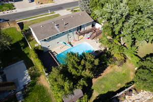 Aerial view of property and surrounding area featuring a pool
