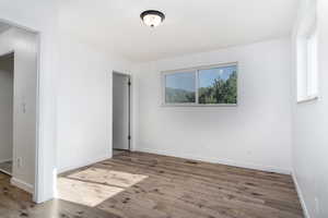master featuring a healthy amount of natural light and wood finished floors