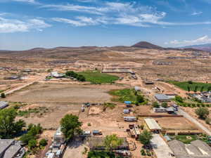 Aerial view of sparsely populated area with a mountain backdrop and a desert landscape