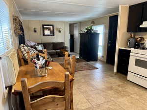 Dining space featuring light tile patterned floors and radiator