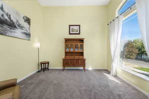 Sitting room featuring carpet and baseboards