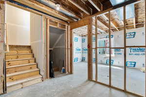 Unfinished below grade area featuring stairs