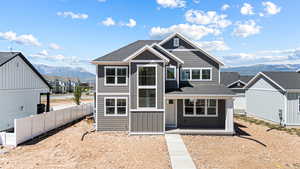 View of front of home featuring a mountain view, roof with shingles, a residential view, and covered porch