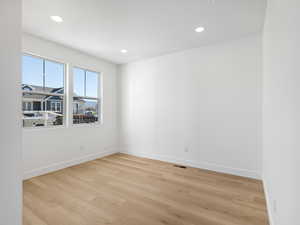 Spare room featuring light wood-type flooring and recessed lighting
