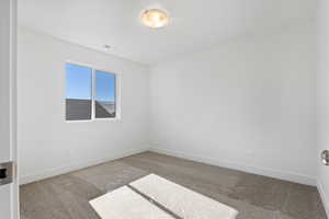 Spare room with carpet floors and baseboards